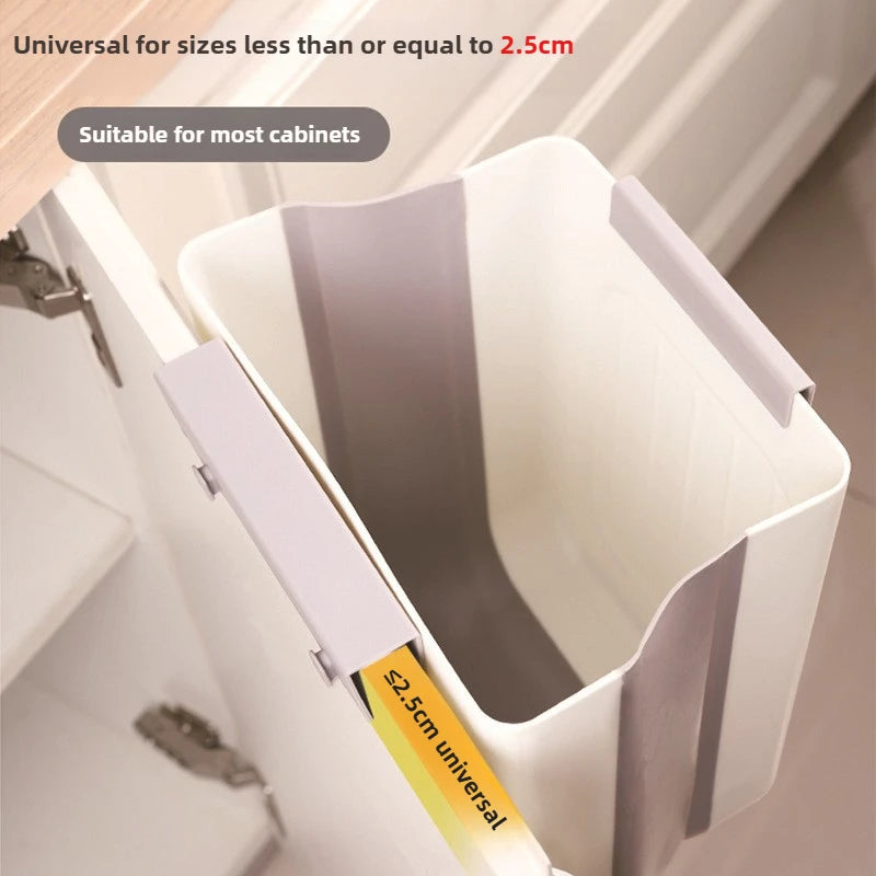 A white foldable hanging trash bin is shown inside a cabinet, demonstrating its universal fit for sizes up to 2.5cm.