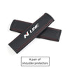 A pair of black PU leather shoulder protectors for car headrests and seatbelts