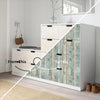 White cabinet with wood grain peel and stick wallpaper featuring blue and gray tones.