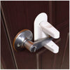 A white adhesive anti-open latch and lever lock mechanism installed on a brown door frame.