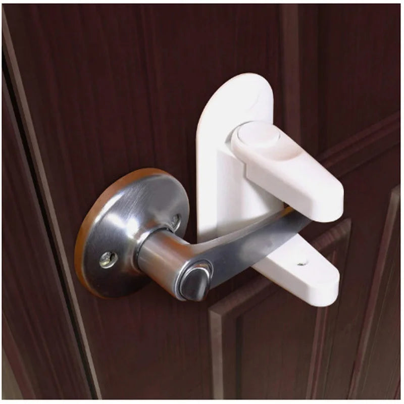A white adhesive anti-open latch and lever lock mechanism installed on a brown door frame.