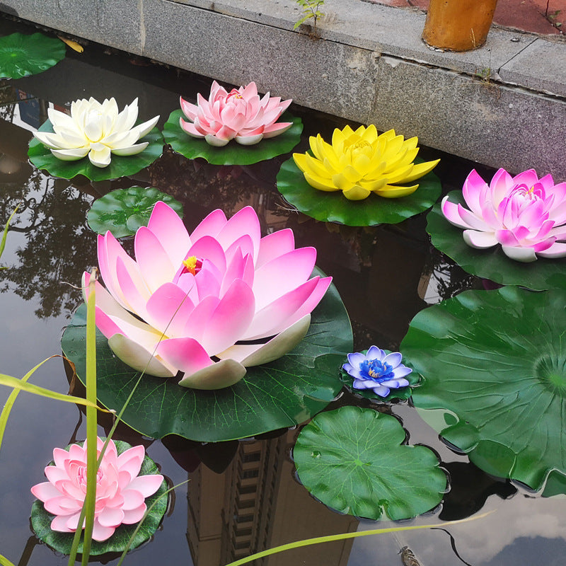 A collection of pink and yellow lotus flowers floating on green lily pads in a pond or garden.