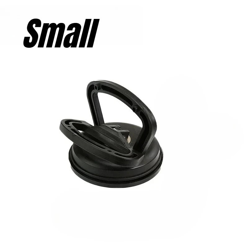 A black heavy-duty suction cup dent puller tool.