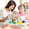 A woman and a child are using a glitter star sticker set to create colorful patterns on a table.