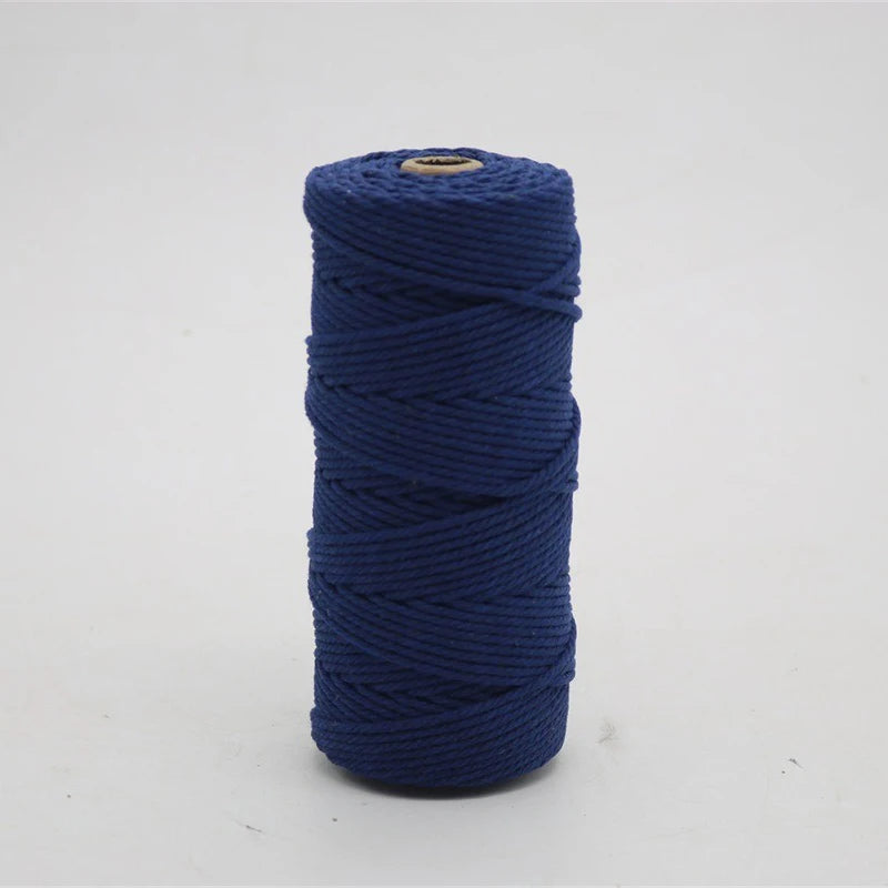 A spool of dark blue macrame cord, 3mm/4mm thickness, used for crafting.