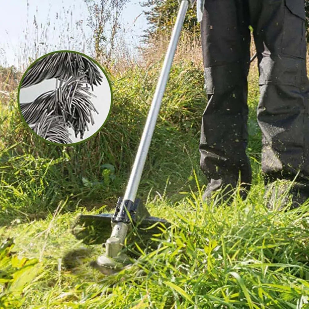 A close-up of a steel wire trimmer head cutting through grass and moss.