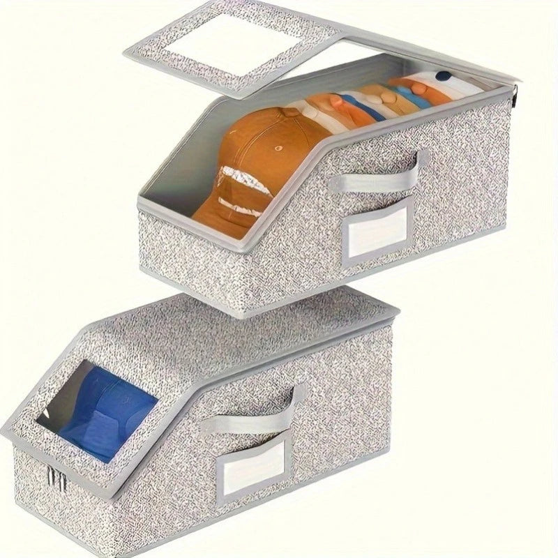 A silver speckled foldable fabric storage box with a lid displaying various hats and accessories.