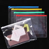 A set of transparent A4 document organizer pockets with colored dividers stacked on a black background.