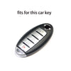 A close-up view of a black silicone key fob cover with various buttons and a silver trim.