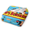 A colorful cartoon-themed throw blanket featuring a burger design and playful characters.