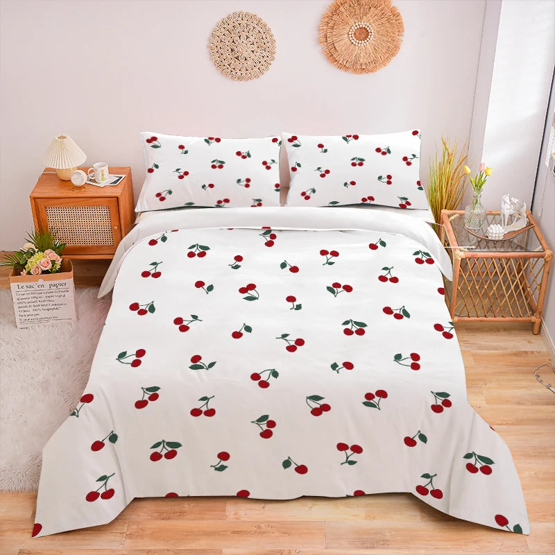 White duvet cover set with a red cherry print featuring scattered cherries and green leaves.