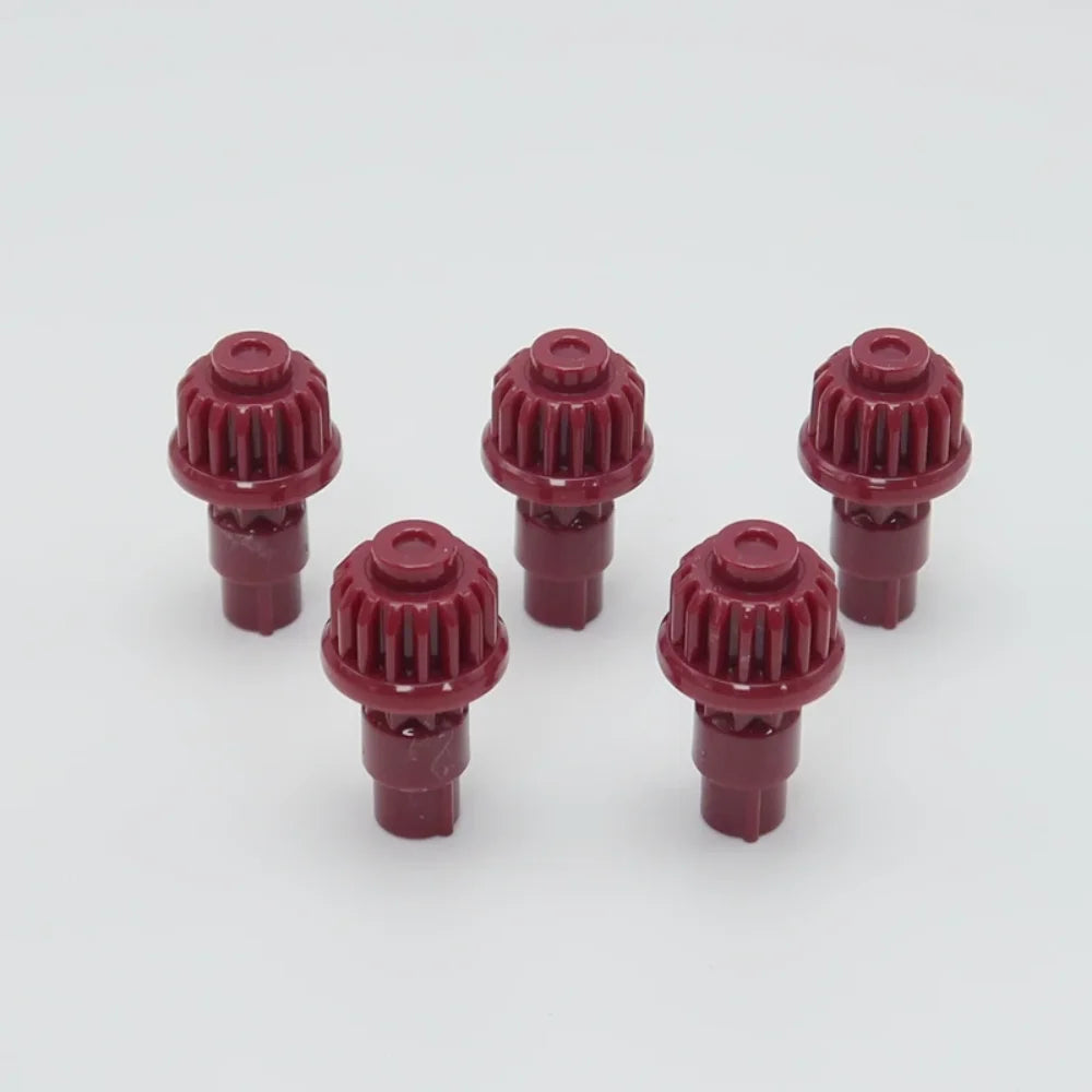 A set of five red replacement drivers for a Battling Top, used to fix or replace the top mechanism.