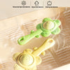A yellow baby teething rattle with a green chewable gripper and shaker toy shown on a translucent surface.