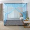 A princess-style lace canopy mosquito net draped over a bed in a bright room.