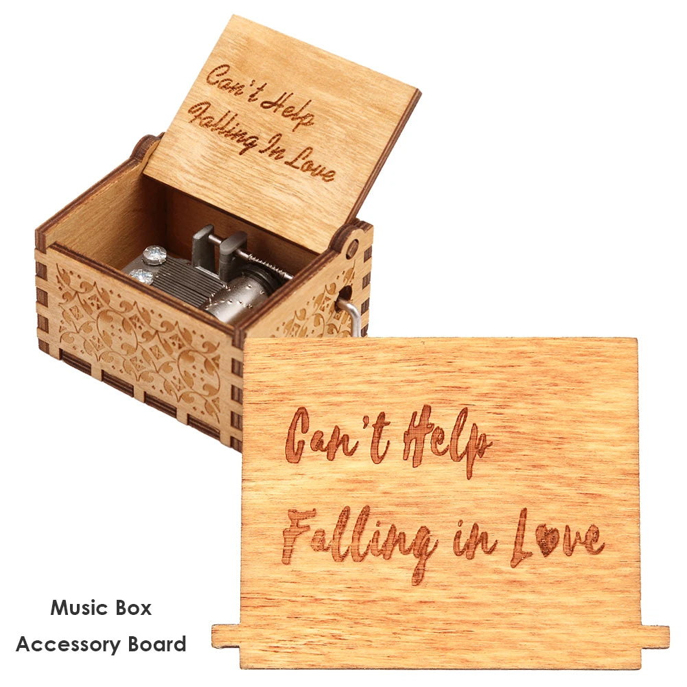 A wooden music box with an accessory board showing the text Can't Help Falling in Love