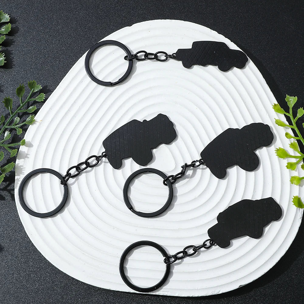 Black Ford Bronco zinc alloy keychain displayed on a white textured surface.