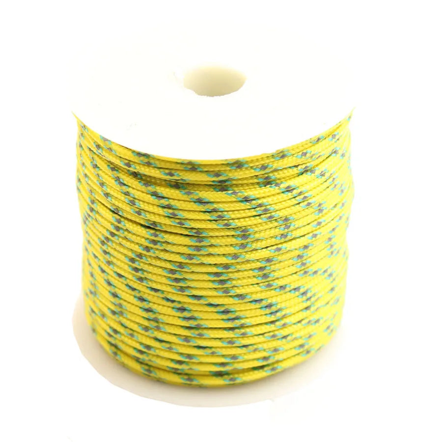 Spool of yellow high-visibility reflective paracord coiled on a white background.