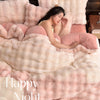 A woman rests her head on a fluffy pink faux fur pillow in a luxurious bedding set.