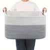A person holds a gray woven cotton rope storage basket for organization.