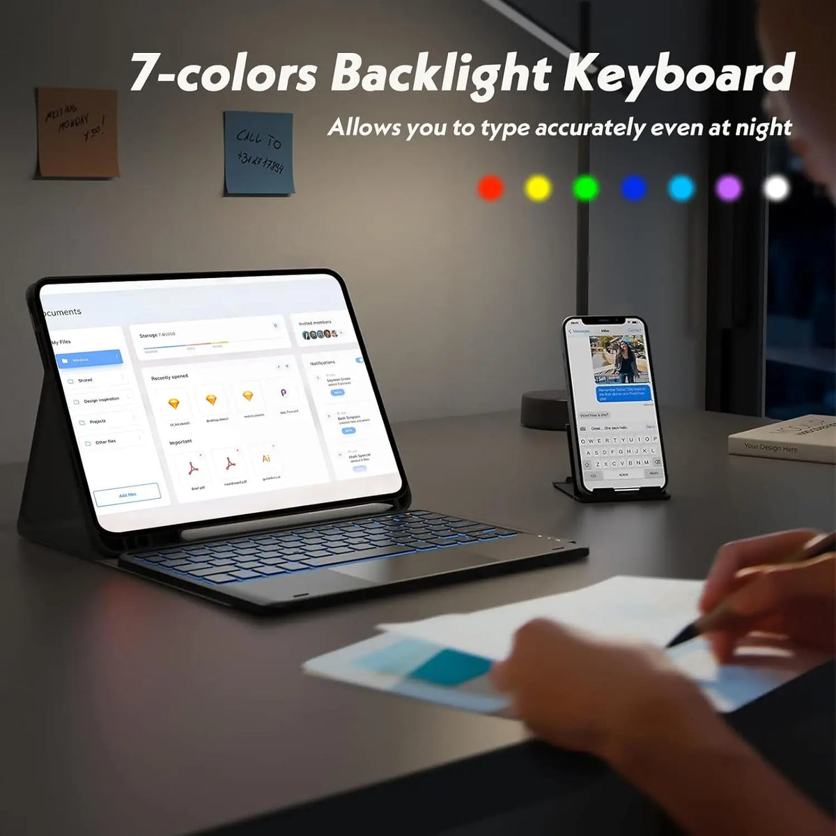 A laptop is shown with a 7-colors backlight keyboard, next to a smartphone and some papers.
