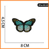 A butterfly embroidered iron-on patch in teal and black on a white background.
