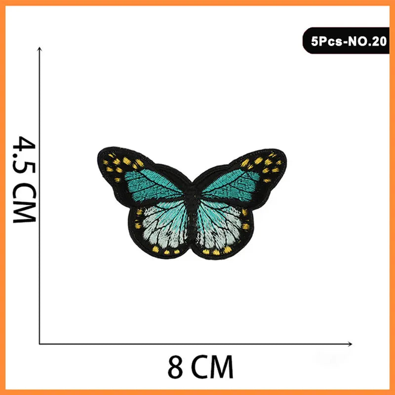 A butterfly embroidered iron-on patch in teal and black on a white background.