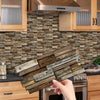 A close-up of a wooden tile backsplash featuring distressed horizontal planks installed behind a stainless steel hood and cab