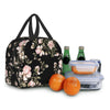 A black insulated lunch bag with a floral watercolor rose pattern next to a glass bottle and a clear food container.