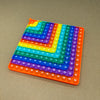 A colorful multiplication practice math game board with 12 rows and 12 columns of numbered tiles.
