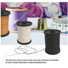 A collection of spools of waxed nylon thread and sewing needles for leather, canvas, and heavy-weight fabrics.