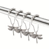 A set of twelve rust-proof metal dragonfly shower curtain hooks hanging from a silver rod.
