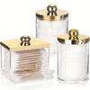 Elegant apothecary jar with a golden lid for storing cotton balls and swabs.