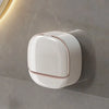 A white wall mounted waterproof soap dish with a rounded design is installed on a gray wall.