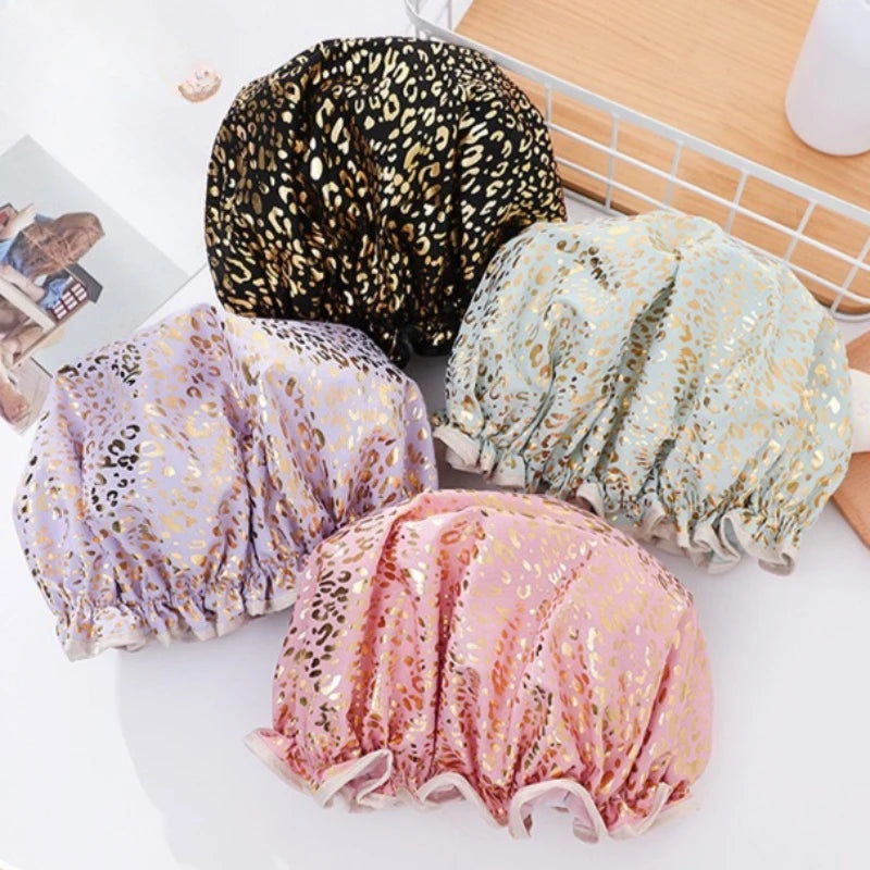 Three reusable elastic shower caps in leopard print, light blue floral, and pink floral are displayed on a white surface.