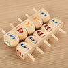 A collection of wooden spinning tops with Japanese characters and letters, including SUN, HE, SHIN, NUN, and NIH, arranged on