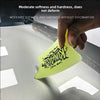 A hand is pressing a yellow TPU car wrap film squeegee onto a silver surface.