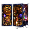 A wooden book nook kit featuring detailed miniature scenes with integrated LED lighting.