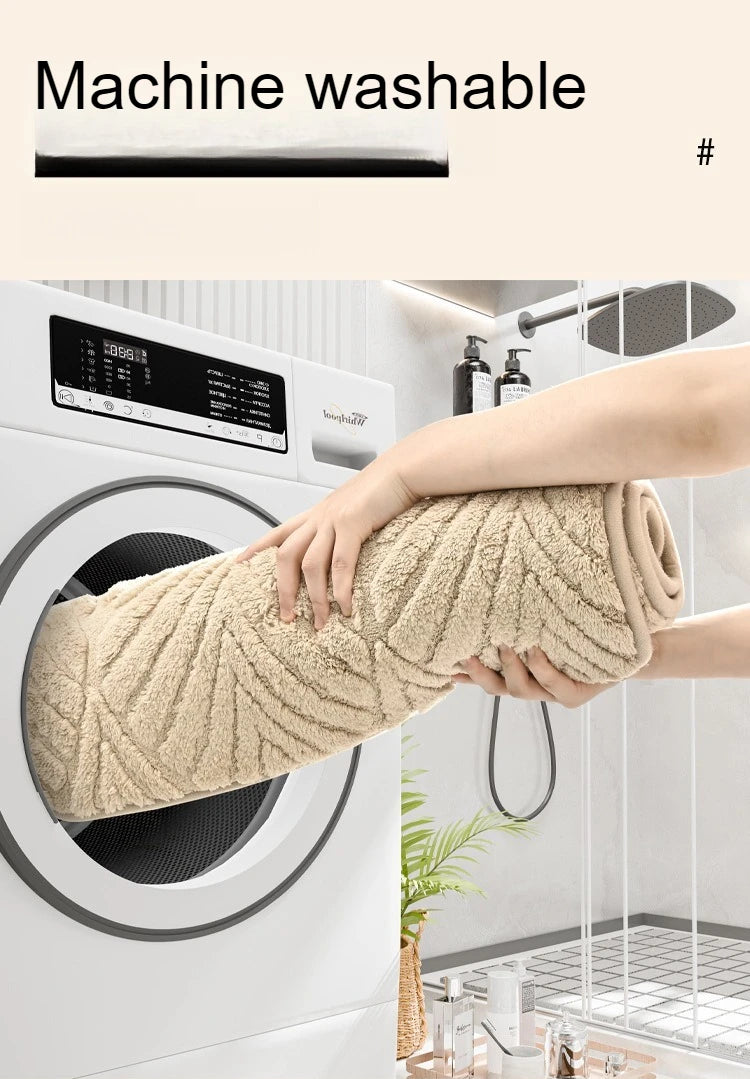 A hand is pulling a beige plush velvet bathroom mat with a non-slip backing out of a white washing machine.