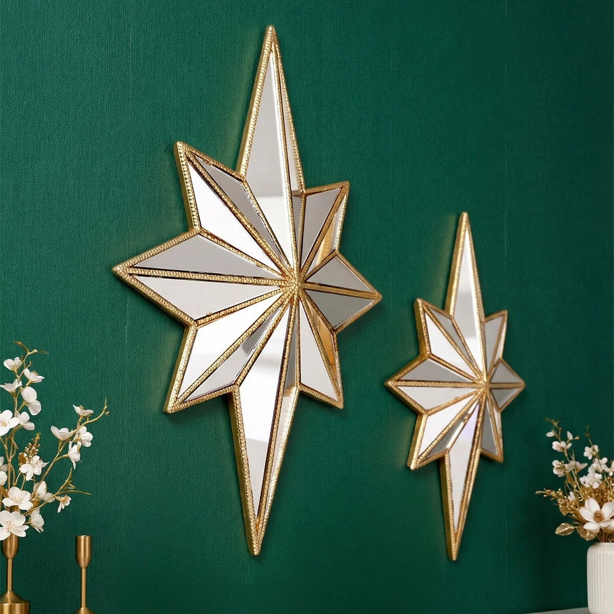 A gold-framed octagonal star resin wall mirror mounted on a dark green wall.