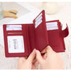A close-up of a maroon RFID-blocking bi-fold wallet showing credit cards inside.