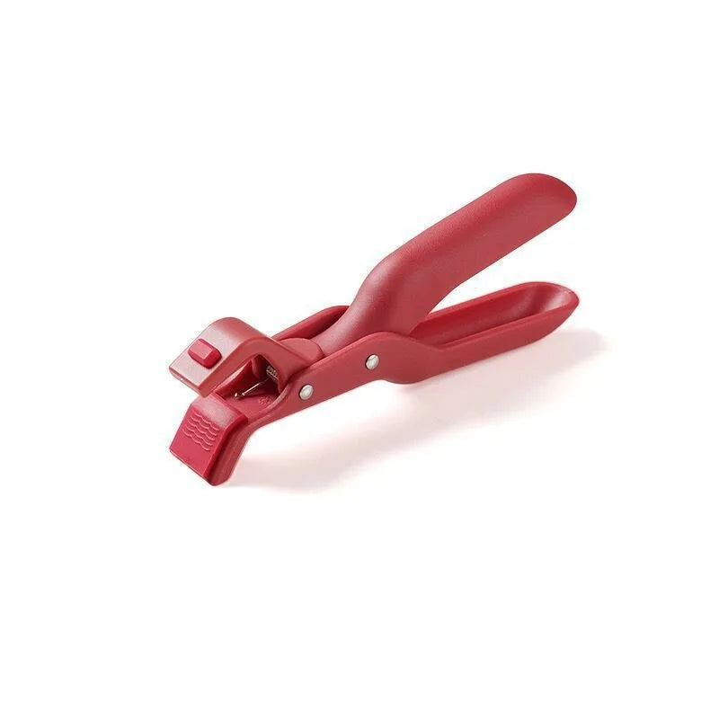 A red heat-resistant silicone bowl and plate gripper clip tool.
