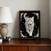 A framed diamond painting featuring a cat silhouette adorned with white pearls and floral accents.