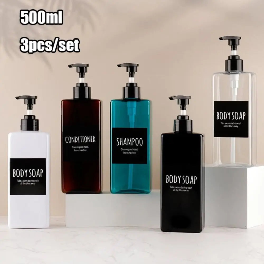 A set of three refillable soap dispenser bottles for body soap, conditioner, and shampoo are displayed on a white surface.