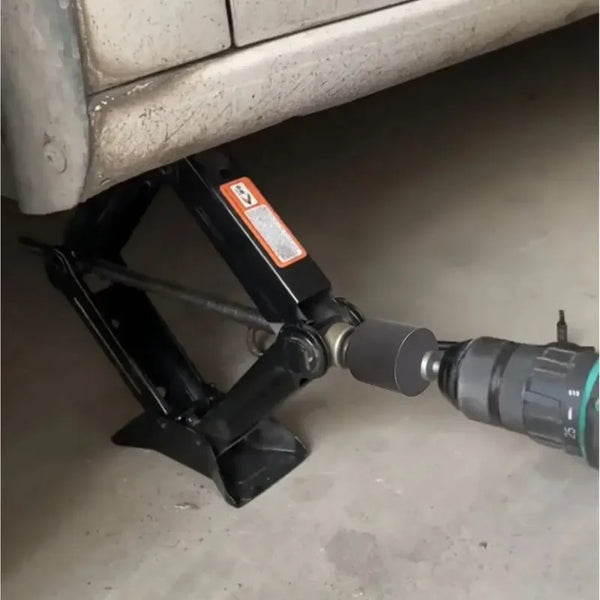 A black heavy-duty drill adapter is shown resting on a light-colored surface.
