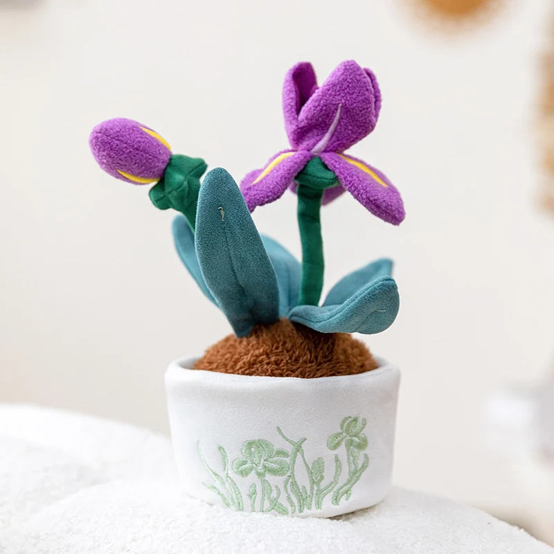 A small artificial flower plush doll with purple petals and green leaves planted in a white pot.