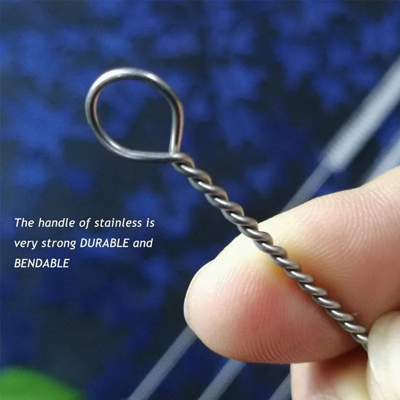 A hand holds a stainless steel reusable straw cleaning brush with a bendable handle against a blue background.
