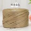 A spool of metallic gold flat ribbon yarn for crochet and knitting