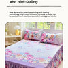 A purple floral print bed skirt and pillowcase set displayed on a bed.