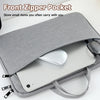 A gray front zipper pocket laptop sleeve case holding a silver tablet or notebook.