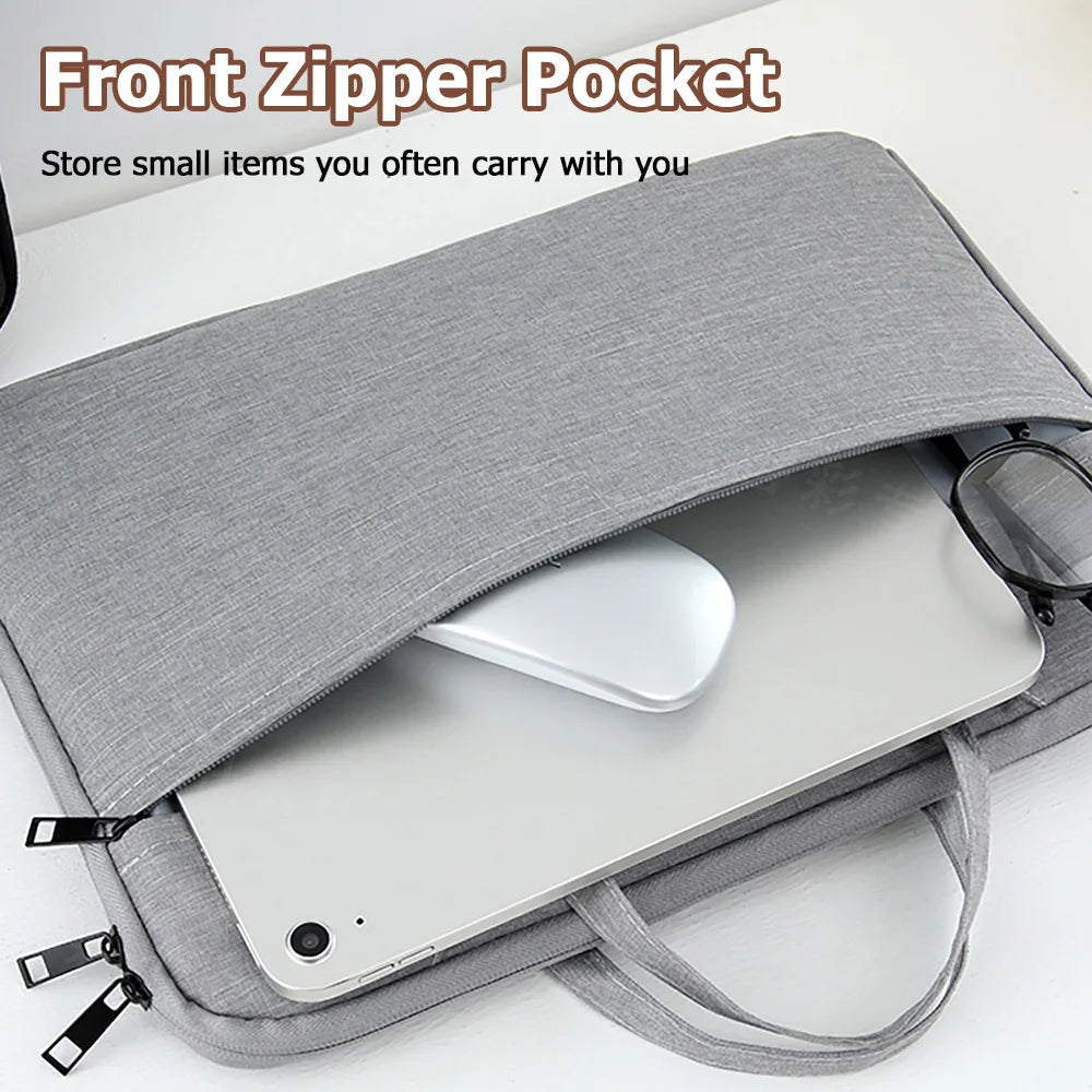 A gray front zipper pocket laptop sleeve case holding a silver tablet or notebook.